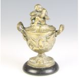 After the antique, a Regency gilt bronze inkwell in the form of a twin handled classical urn, the