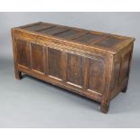 An 18th Century oak coffer of panelled construction with hinged lid, fitted a candle box 71cm h x