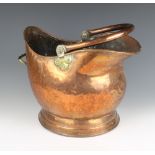 A copper and brass helmet shaped coal scuttle with swing handle (some dents) 37cm x 27cm