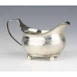 A George III silver cream jug raised on ball feet, London 1812, 100 grams