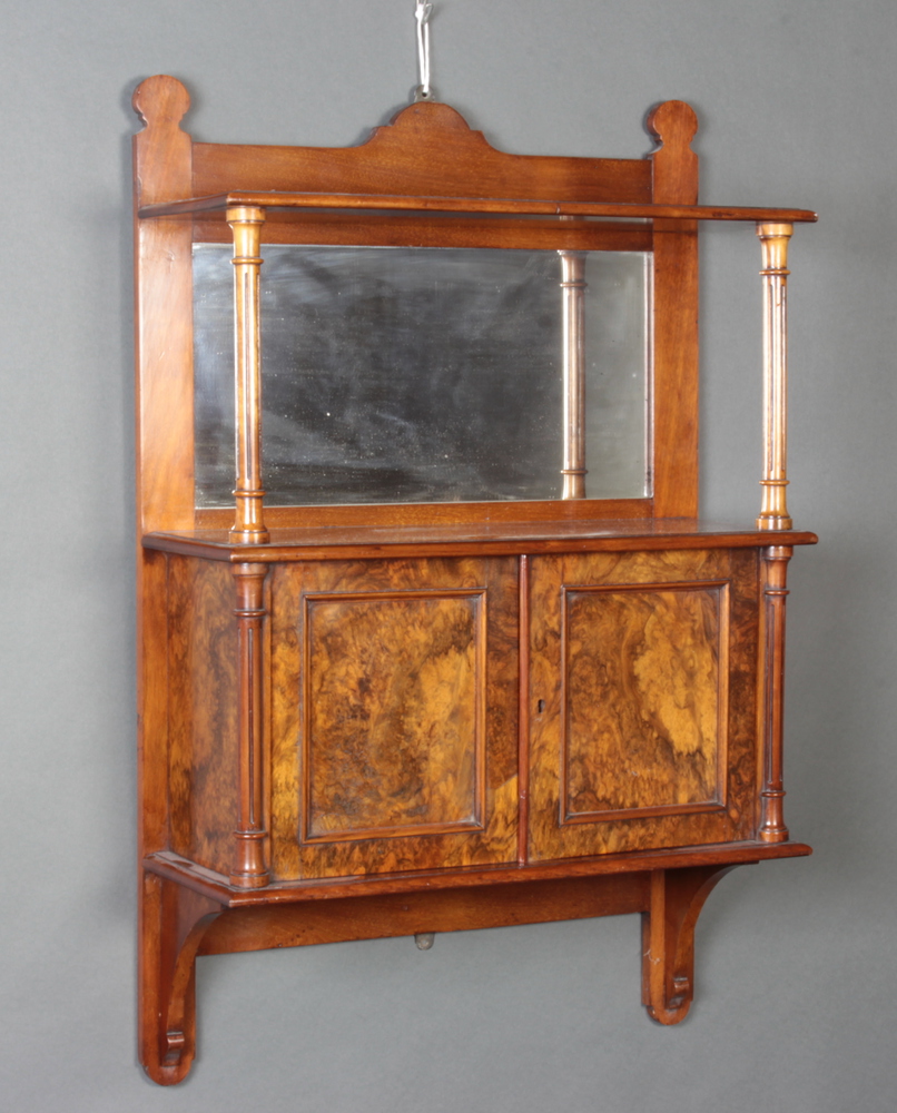 A Victorian walnut and burr walnut hanging cabinet with raised back fitted a mirror, the base