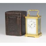 A 19th Century 8 day striking carriage clock contained in a gilt metal case, the enamelled dial with