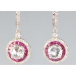 A pair of 18ct yellow gold ruby and diamond earrings, the centre diamonds approx 1.01ct each,