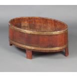 A Georgian oval mahogany and brass banded wine cooler raised on shaped supports 37cm h x 76cm w x