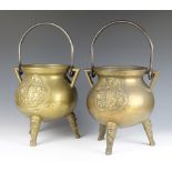 A pair of Continental cast gilt metal cauldrons with iron swing handles decorated classical