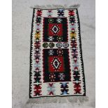 A white, black, red and blue ground Turkish Kilim rug 140cm x 74cm