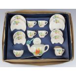 A child's 1930's tea set comprising teapot, milk jug, 4 tea cups, 4 saucers, sugar bowl, 4 side