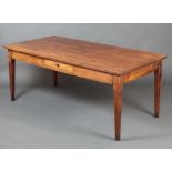 A 19th Century French cherry wood dining table, the top of plank construction, fitted a frieze