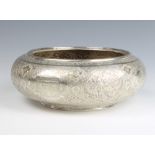 An early 20th Century Persian repousse silver shallow bowl decorated with panels of animals, birds