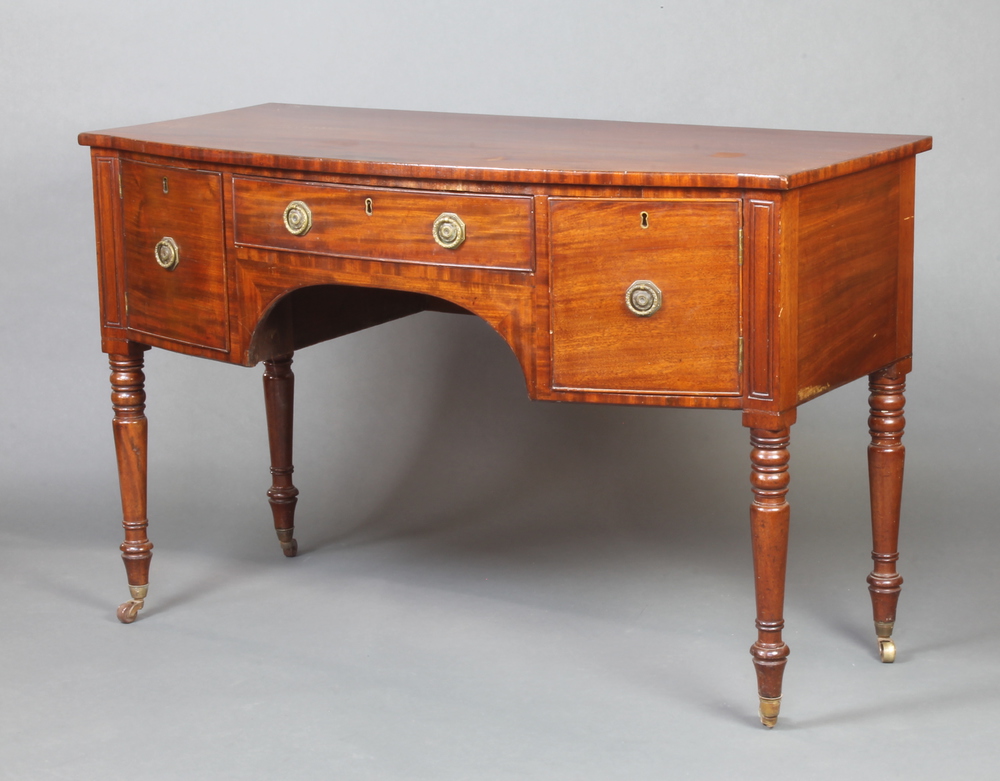 A Regency mahogany bow front sideboard fitted 1 long drawer flanked by a pair of cupboards