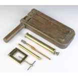 A 19th Century wooden bird scaring rattle, a brass cased thermometer, a large brass syringe, a