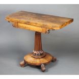 A Regency rosewood D shaped card table raised on turned and fluted column with circular base and