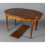 An Edwardian walnut oval extending dining table raised on square tapered supports, spade feet 75cm h