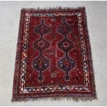 A red and blue ground Persian Qashqai rug with 2 rows of diamond medallions to the centre within a