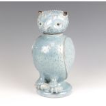 An early 20th Century studio pottery ewer and cover in the form of an owl sitting on a trunk, raised