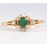An 18ct yellow gold emerald and diamond ring size S 1/2
