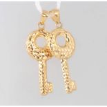 Two 9ct yellow gold bright cut key charms, 1 gram