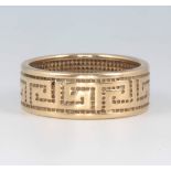 A 9ct yellow gold Greek key pattern wedding band, size R, 5.7 grams