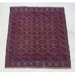 A red and blue ground Gazak rug with numerous diamonds to the centre in a multi-row border 126cm x