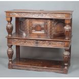 A 17th Century style Ipswich oak court cupboard, the upper section enclosed by panelled doors, the