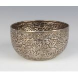 An Indian repousse silver bowl decorated with animals amongst trees, 131 grams 10.5cm