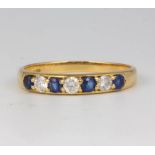 An 18ct yellow gold diamond and sapphire ring size N