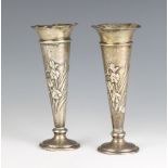 A pair of Art Nouveau silver repousse tapered spill/posy vases decorated with Irises London 1904,