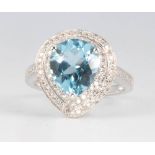 A 14ct white gold pear cut topaz and diamond ring, the centre stone approx. 4.42ct, the brilliant