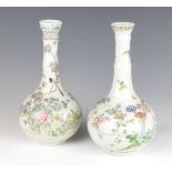 A near pair of Japanese bottle vases decorated with birds amongst flowers 25cm 1 has a chipped base,