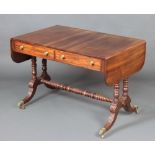 A Victorian mahogany sofa table fitted 2 long drawers raised on 4 columns with ring turned H