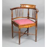 An Edwardian inlaid mahogany tub back corner chair with spindle decoration and upholstered seat,