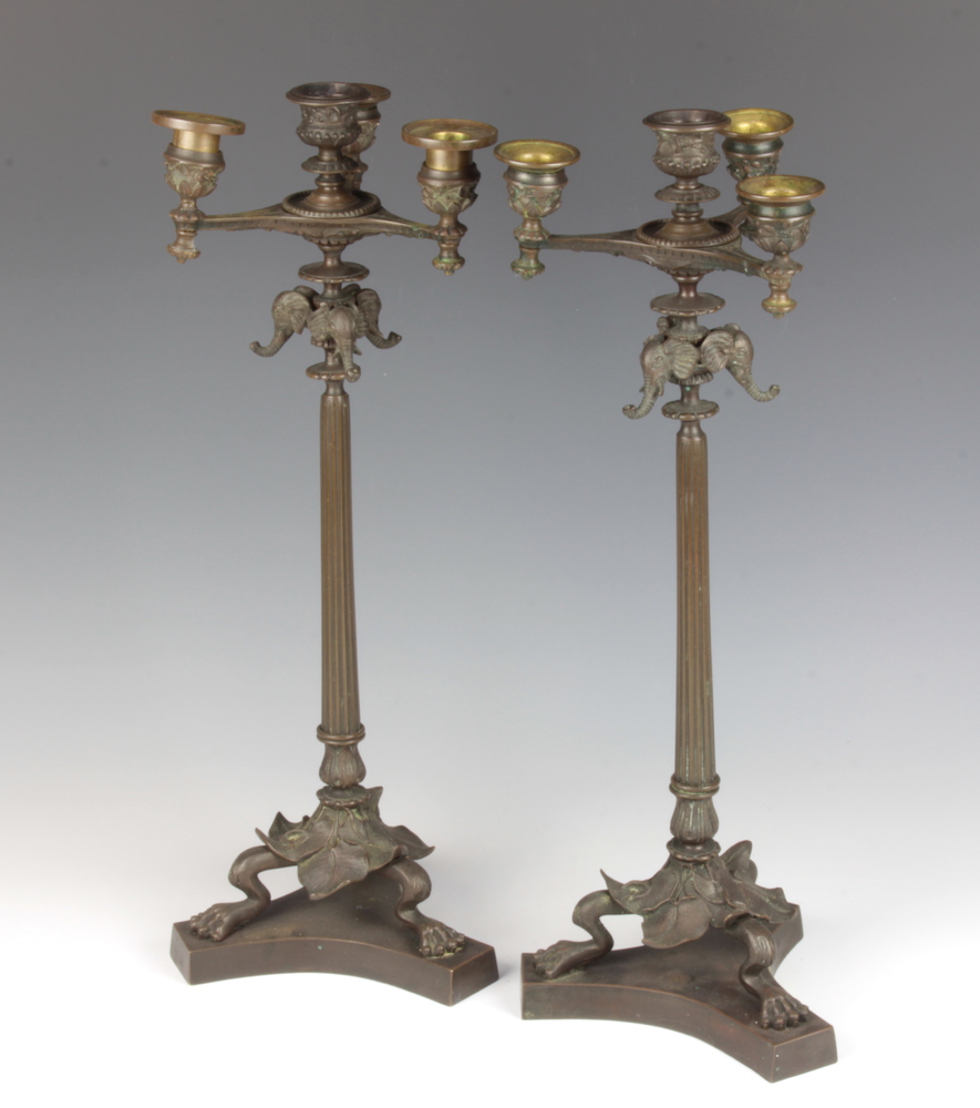 A pair of Regency style bronze 5 light candelabrum with elephant decoration raised on fluted columns