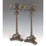 A pair of Regency style bronze 5 light candelabrum with elephant decoration raised on fluted columns