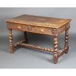 A Victorian carved oak Carolean style table fitted 2 drawers, raised on spiral turned supports