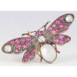 An Edwardian style silver gilt novelty brooch in the form of a moth set with moonstones and rubies