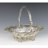 A Georgian silver pierced and cast basket with swing handle decorated with flowers and swags, raised