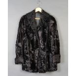 A lady's black Persian lamb quarter length jacketSome wear to the cuffs, pocket and front