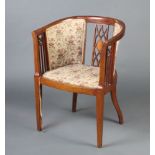 An Edwardian inlaid mahogany tub back chair with upholstered seat and back, raised on square tapered