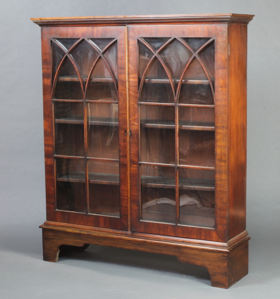 A 19th Century mahogany bookcase with moulded cornice, fitted shelves enclosed by astragal glazed