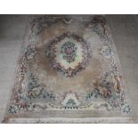 A sand grown and floral patterned Chinese carpet 372cm x 276cm There is old moth damage and some