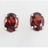 A pair of silver garnet ear studs 1.2ct