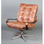 A 1960's chrome and leather revolving open arm chair