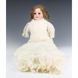 A Victorian Armand Marseille porcelain headed doll with sleep eyes, open mouth with teeth, the