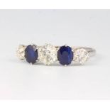 A platinum 3 stone diamond and 2 stone sapphire ring, the diamonds approx 0.3, 0.7 and 0.3 carat,