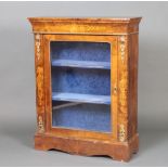 A Victorian inlaid figured walnut pier cabinet with gilt metal mounts enclosed by a glazed
