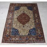 A brown and blue ground Tabriz carpet with central medallion 324cm x 227cm