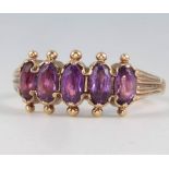 A 9ct yellow gold 5 stone amethyst ring size N