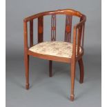 An Edwardian inlaid mahogany tub back chair with upholstered seat, raised on square tapered
