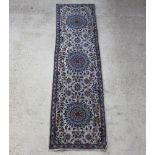 A Persian blue and white ground Nir runner with 3 medallions to the centre 288cm x 79cmSlight