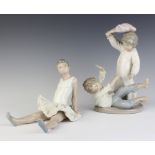 A Nao figure of a seated ballerina 17cm, ditto of two boys playing 24cm
